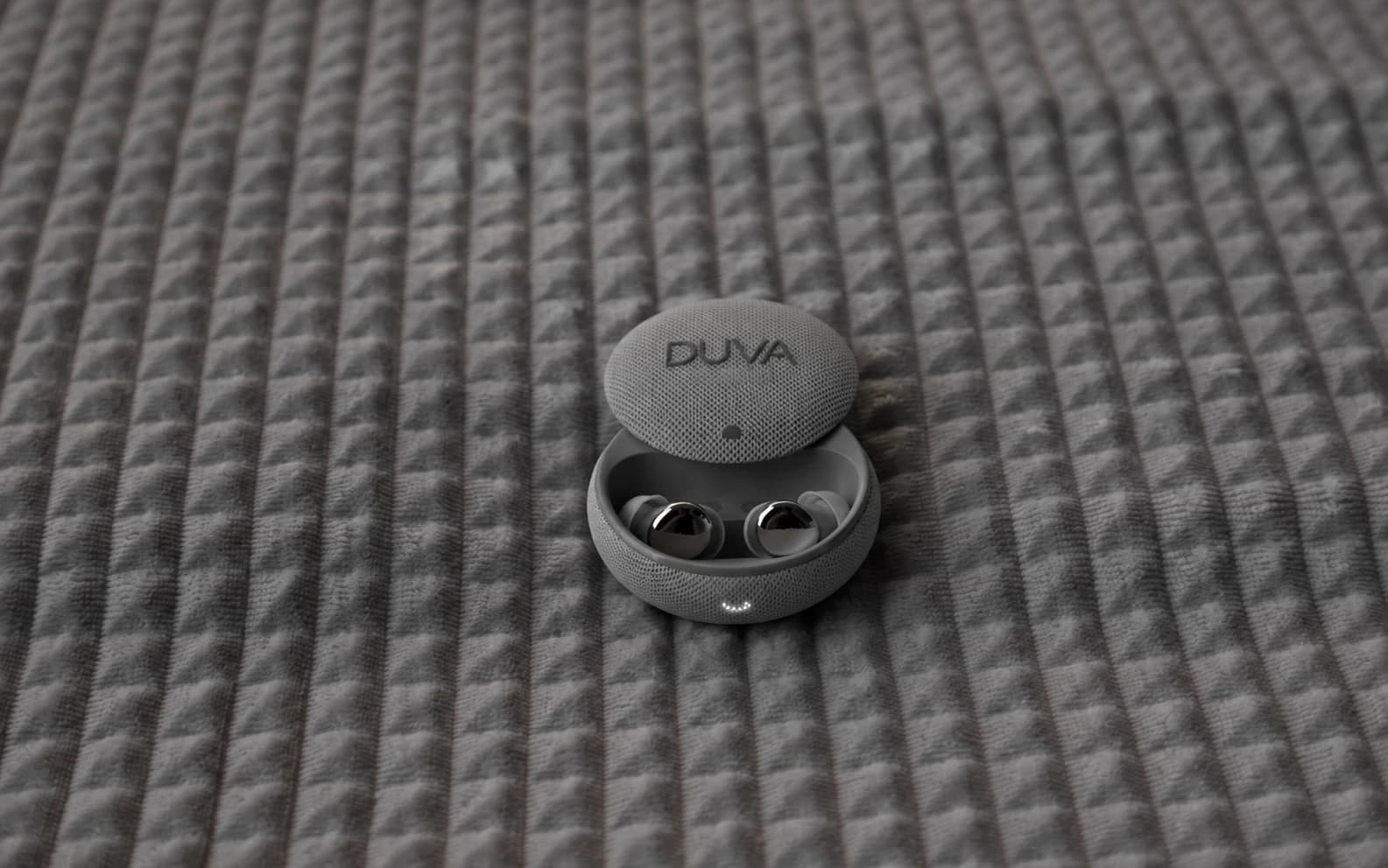 An open DUVA earbud charging case resting on a textured bedspread.